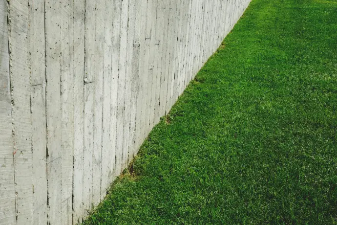 brown wooden fence on green lawn field